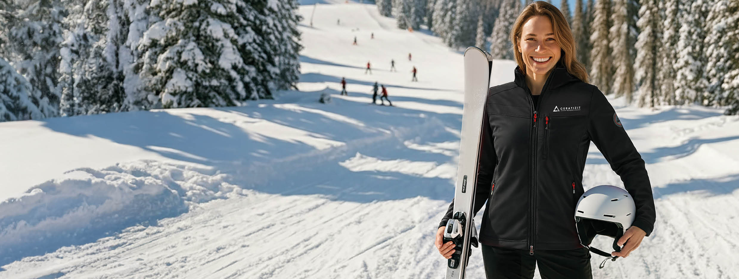 Woman in winter gear standing on a ski slope background